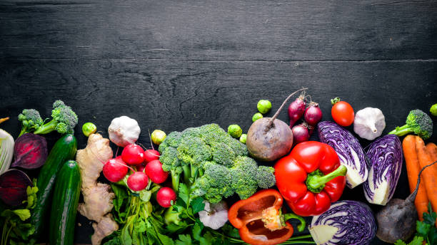 istock Big set organic food. Fresh raw vegetables. On a black chalkboard. 873865348