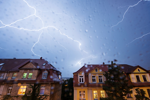 Weimar, Germany: Lightning during a thunderstorm in the city .