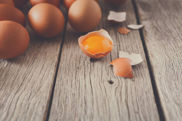 istock Fresh chicken brown eggs on rustic wood, organic farming concept 873866006