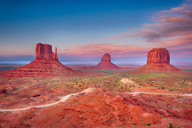 Monument Valley Beautiful dramatic sunset over the East, West Mitten Butte and Merrick Butte in Monument Valley. Utah, USA merrick butte stock pictures, royalty-free photos & images