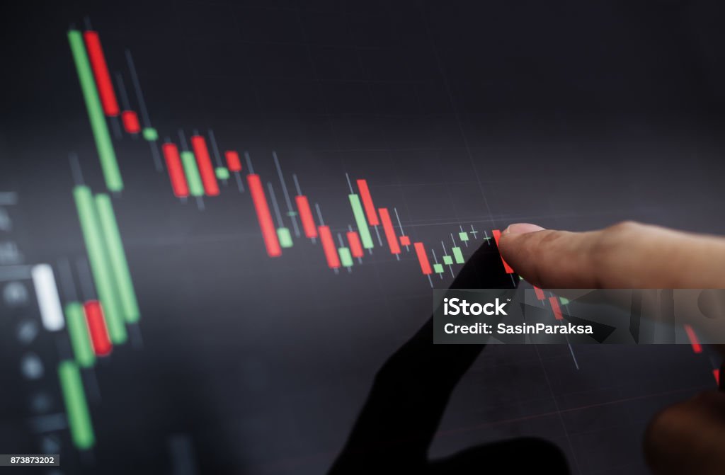 Close-up finger pointing on stock exchange chart Stock Market and Exchange Stock Photo