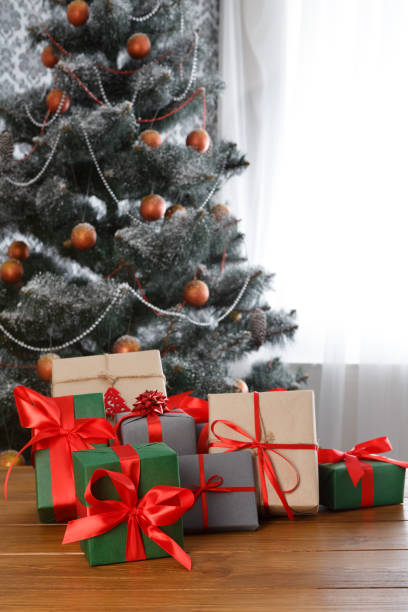 istock Christmas present on decorated tree background, holiday concept 873874336