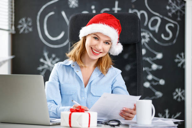istock businesswoman freelancer working at a computer at Christmas 873875532
