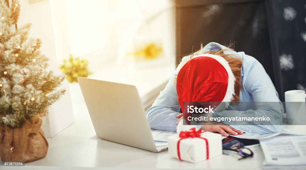 businesswoman freelancer tired, asleep working at computer at Christmas business woman businesswoman freelancer tired, asleep working at computer at Christmas Christmas Stock Photo