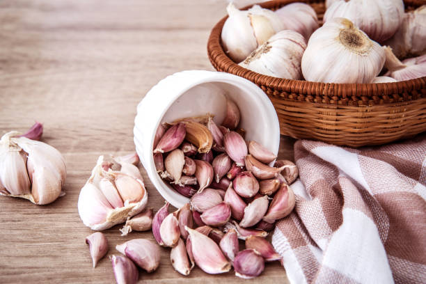 istock Close up  group of garlic on kitchen wooden table 873875922
