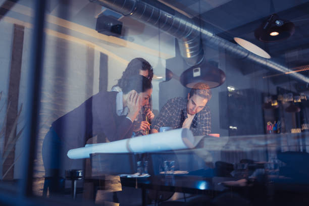 istock Working Late. Group of young architects working late in office 873882002