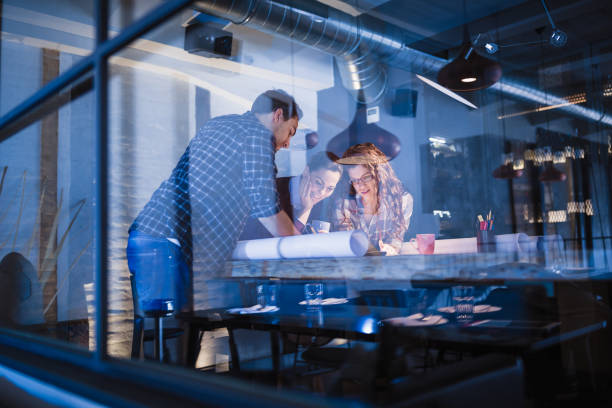 istock Working Late. Group of young architects working late in office 873882342
