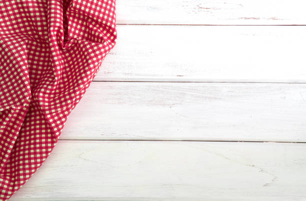 istock The Crumpled red checkered tablecloth or napkin on empty white wooden table with copy space for food cooking  menu background concept , top view or overhead shot 873882532