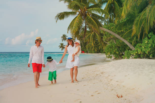 istock happy family with two kids walking on beach 873887334