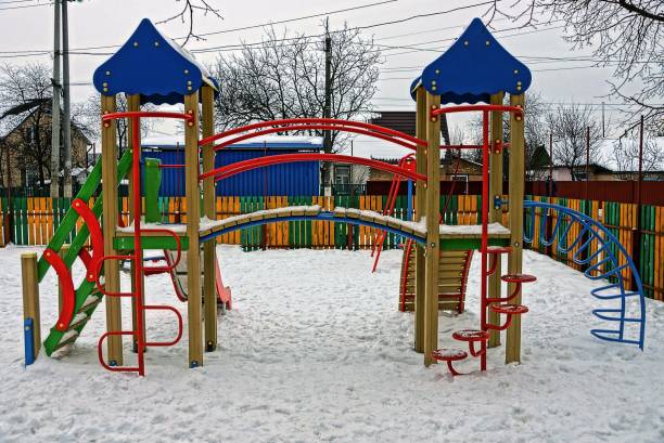 istock colored empty playground under the snow on the street 873887506