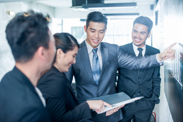 Asian Businessman Young Asian business people at work. small business malaysia stock pictures, royalty-free photos & images