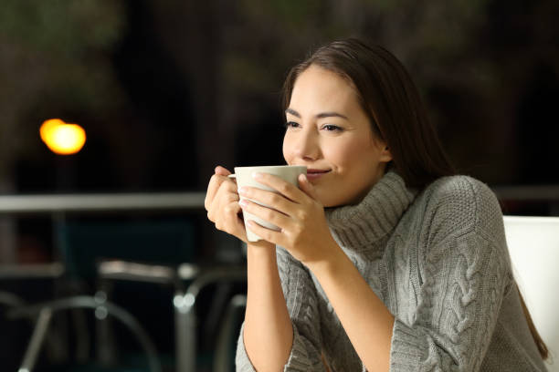 istock Pensive woman enjoying cofee in a bar at night 873895202
