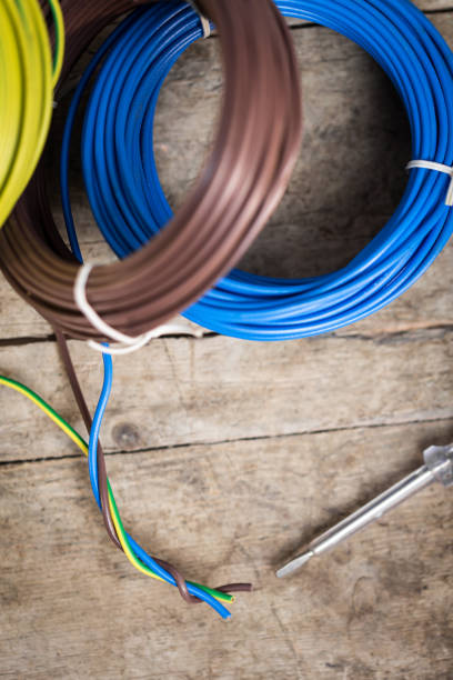 istock different electric cables on a wooden table, close-up with test light 873895844