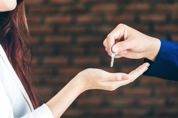 istock Businessman giving a key 873900282