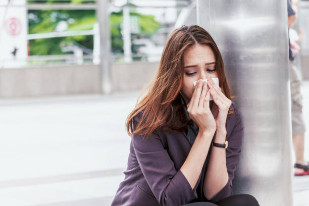 istock Sick business woman with sneezing in tissue 873902236