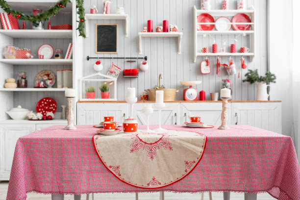 istock Interior light grey kitchen and red christmas decor. Preparing lunch at home on the kitchen concept. Focus on table 873907828