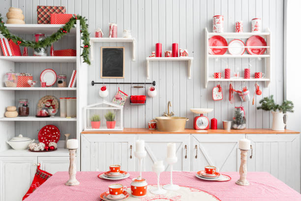 istock Interior light grey kitchen and red christmas decor. Preparing lunch at home on the kitchen concept. 873908076