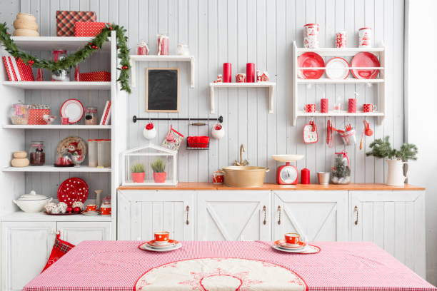 istock Interior light grey kitchen and red christmas decor. Preparing lunch at home on the kitchen concept. 873908392