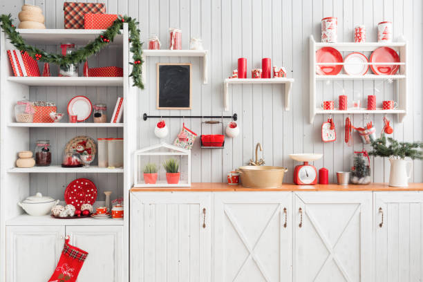 istock Interior light grey kitchen and red christmas decor. Preparing lunch at home on the kitchen concept. 873908466