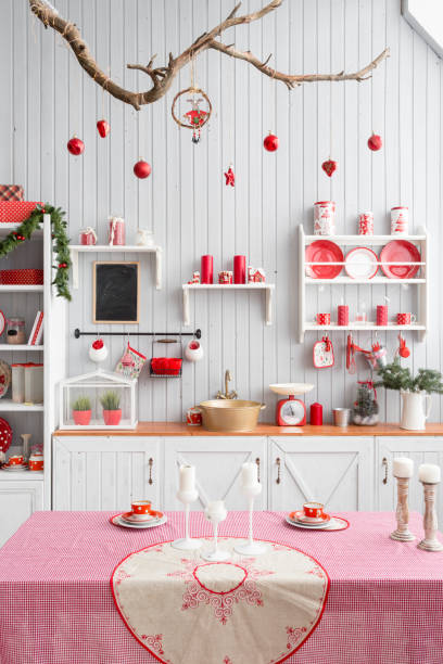 istock Interior light grey kitchen and red christmas decor. Preparing lunch at home on the kitchen concept. 873908586