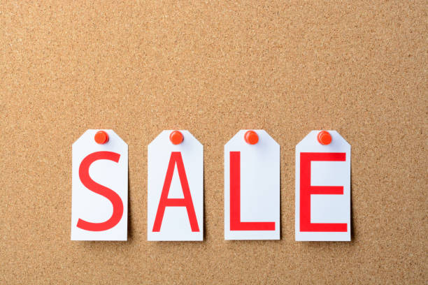 istock Tags with the word SALE pinned to a cork Board 873908632
