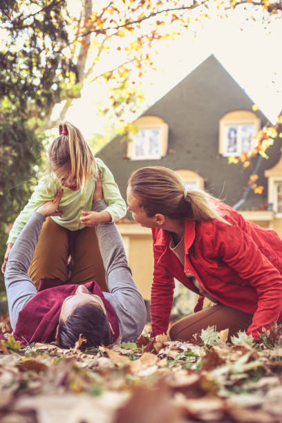 istock Mother and father have play with daughter at backyard. 873909410