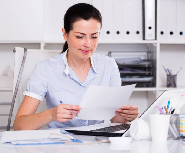 istock Thinking female in office sitting at the table 873913210