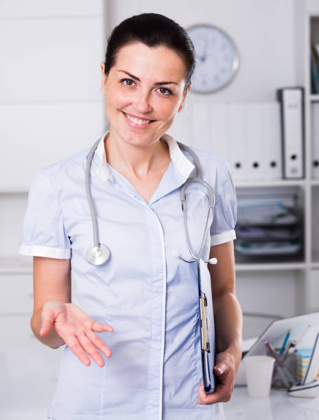 istock smiling doctor offering one hand 873913254