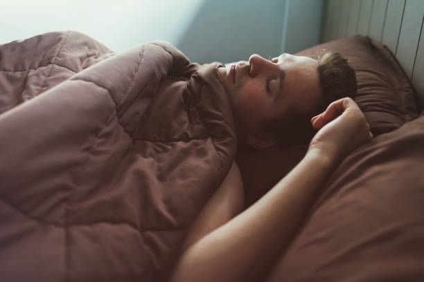 istock Caucasian man napping in bed in the morning. 873927986
