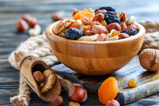 istock Wooden bowl with nuts and dried fruits. 873931774