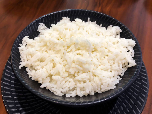 Freshly Cooked Jasmine Rice Freshly cooked Jasmine rice served in a ceramic bowl jasmine rice stock pictures, royalty-free photos & images