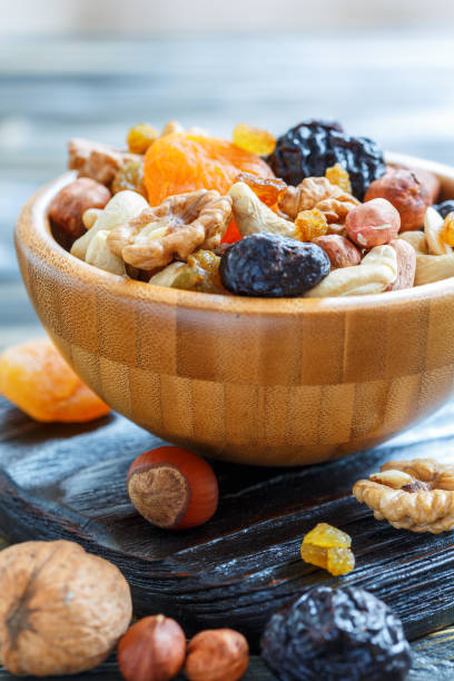 istock Nuts and dried fruit in a wooden bowl. 873933112