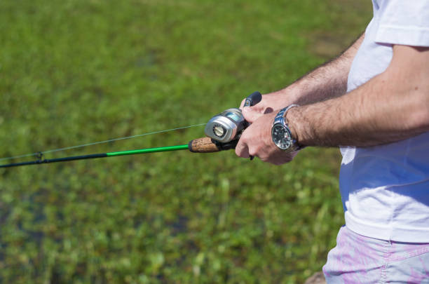istock Young man fishing in pond 873933210