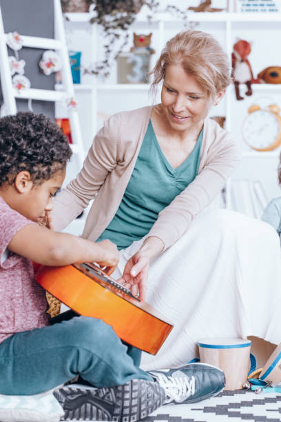 istock African-american boy playing guitar 873933308