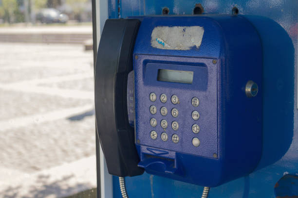 istock Old blue telephone set on the street 873936216