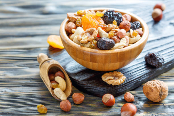 istock Nuts and dried fruit in a wooden bowl. 873936690