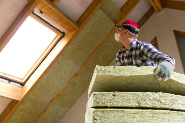 istock Man installing thermal roof insulation layer - using mineral wool panels. Attic renovation and insulation concept 873936804