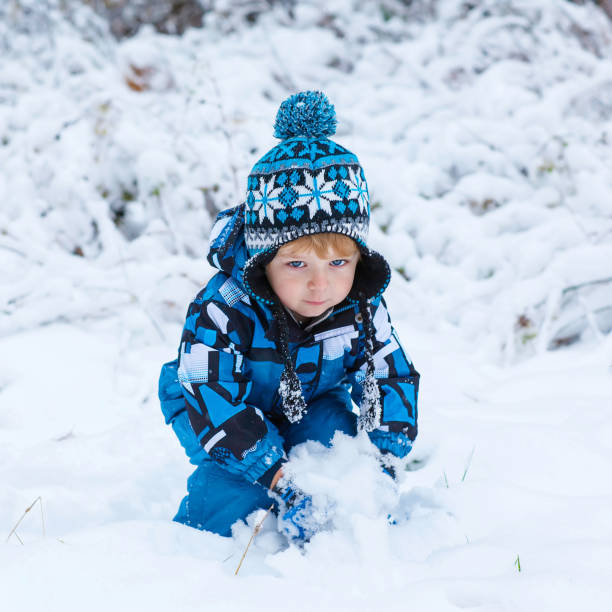 istock Happy child having fun with snow in winter 873937042