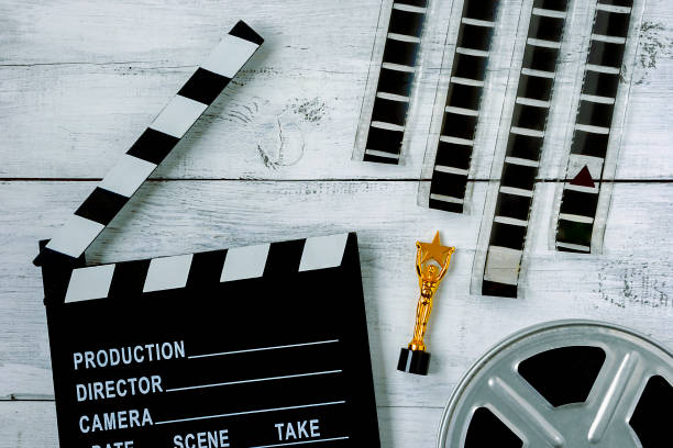 istock Clapperboard and coil with film 873937858