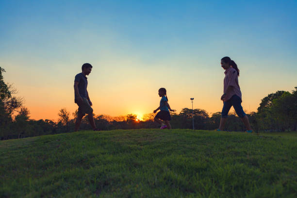 istock Family silhouette with sunset. 873942056