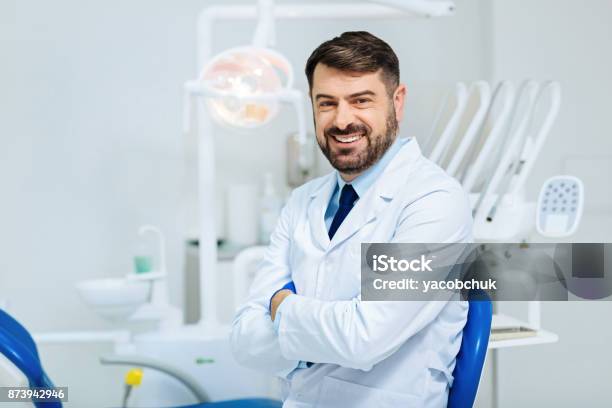 Kind Hearted Glance Of Professional Dentist Stock Photo - Download Image Now - Dentist, Smiling, Medical Clinic