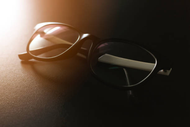 istock closeup eyeglasses on black table with soft-focus and over sunlight in the background 873945016