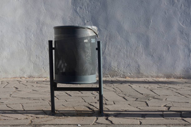 Modern Metallic trash bin in a sunny urban environment