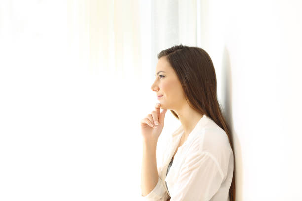 istock Profile of a woman thinking at home on white 873946804