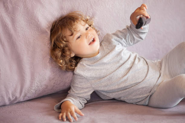istock Toddler kid watching tv cartoons. 873952160