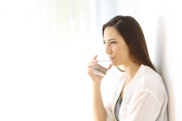 istock Woman drinking water isolated at side 873953318