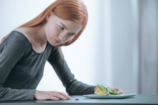 istock Slim girl looking at breakfast 873960474