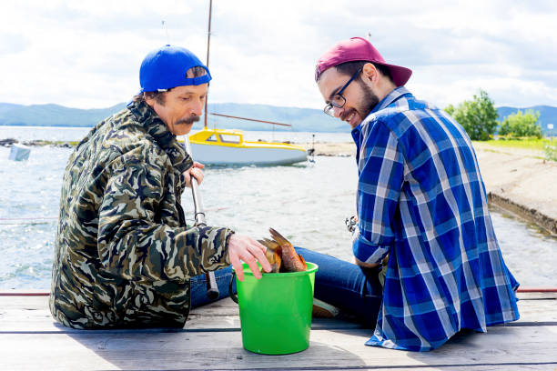 istock Father and son fishing 873960484