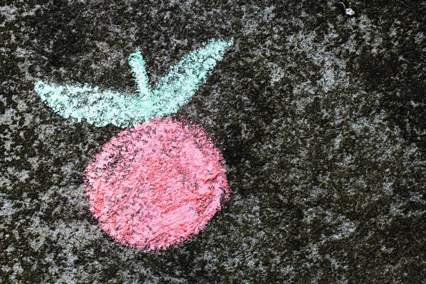 istock Colorful chalk drawing on asphalt: tasty fresh apple or tomato 873961764