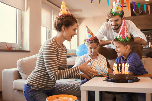 istock young family having fun celebrating birthday 873964934